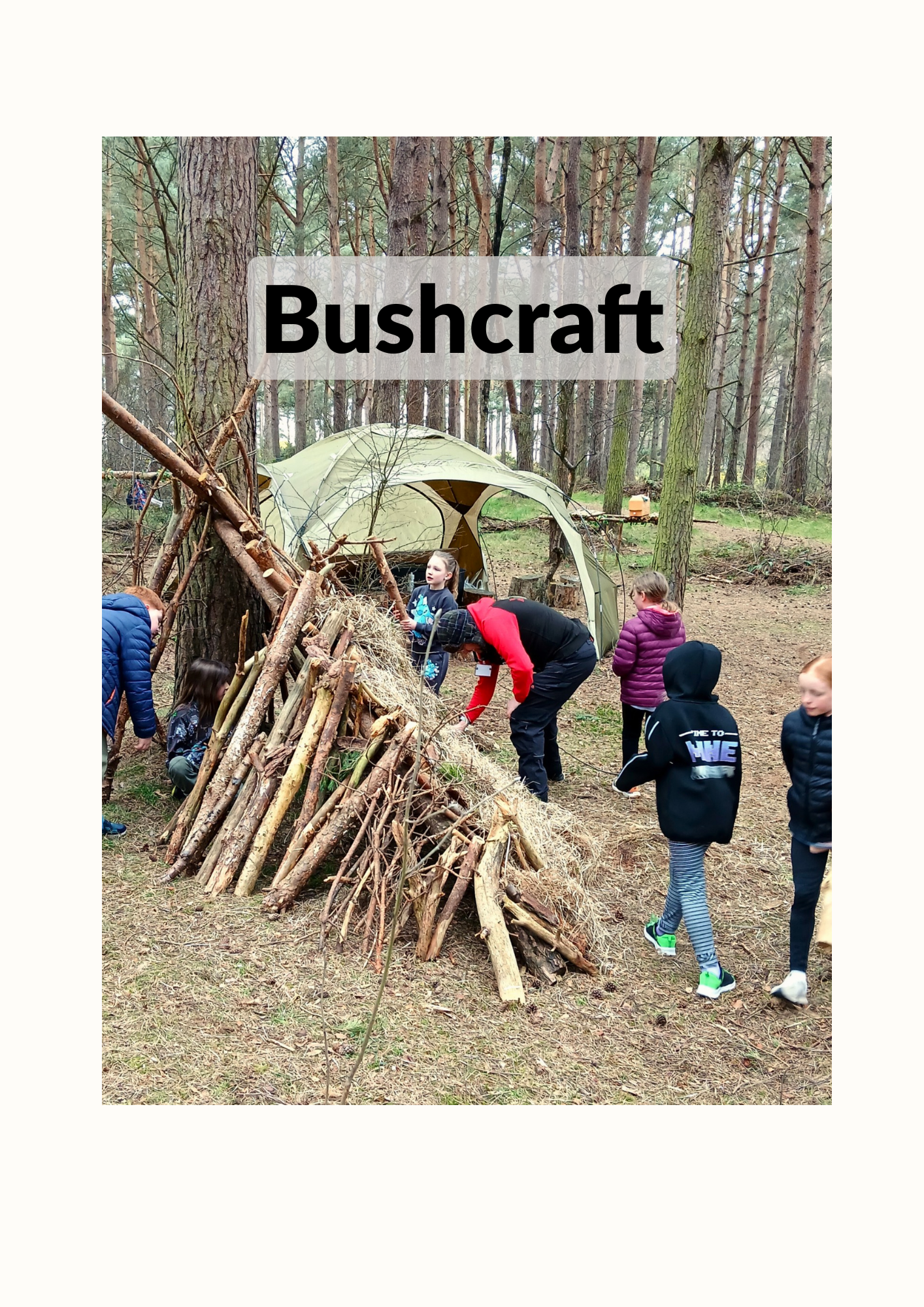 group of children enjoying shelter building in the woods with our Bushcraft session
