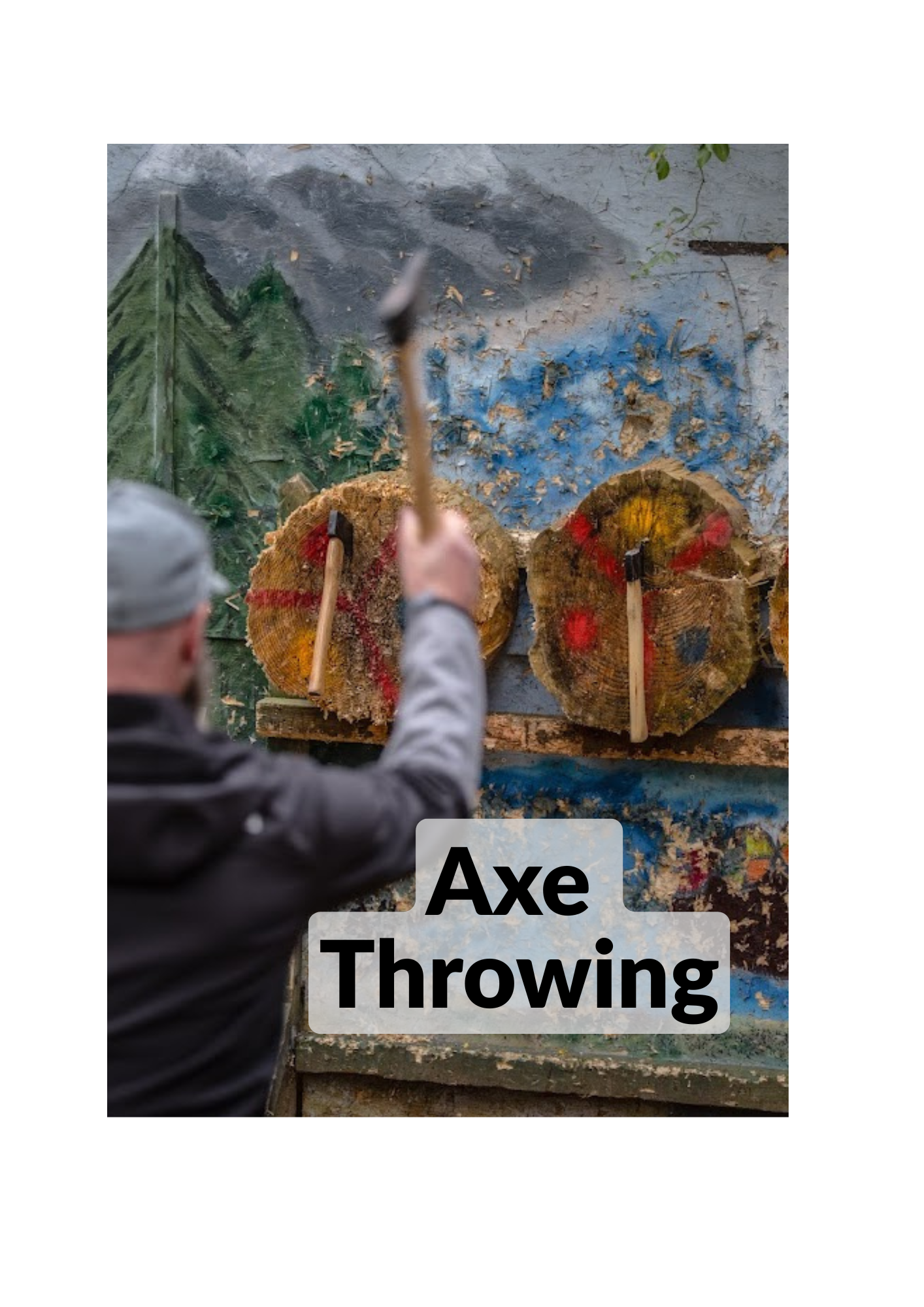 Man throwing Axes in the axe throwing zone