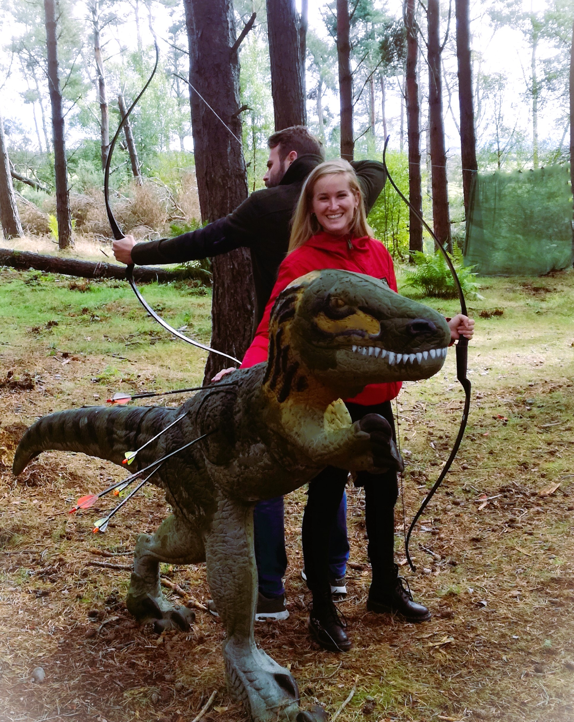 Couple with archery target of dinosaur