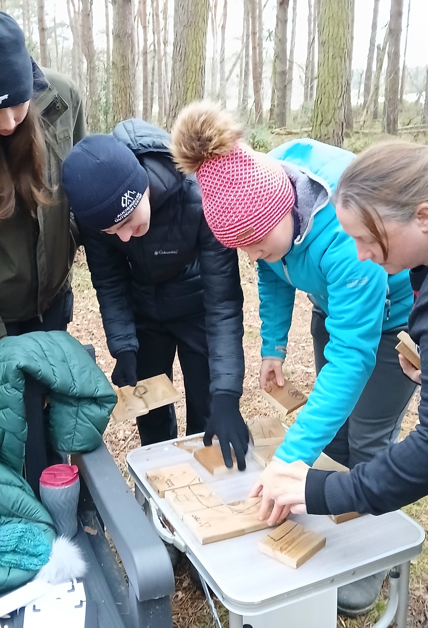 Group of people building a map in an outdoor escape room session